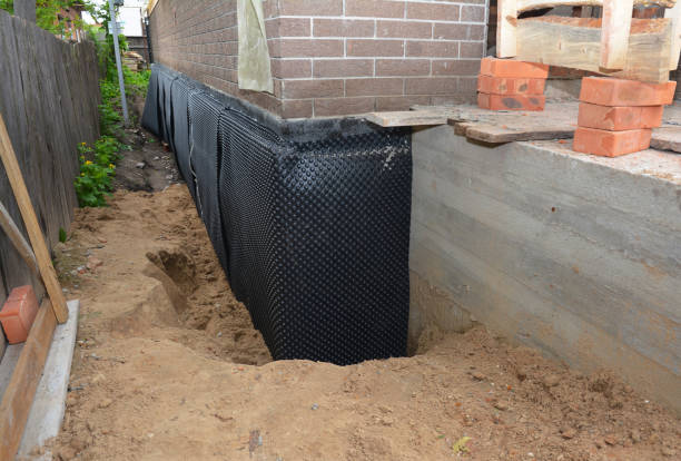 Happy homeowners after waterproofing job in Brockport